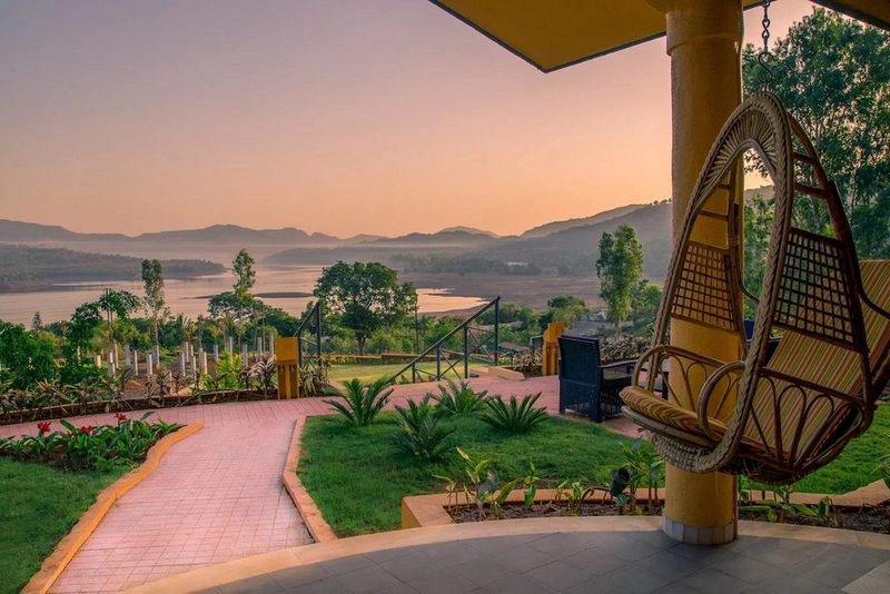 Garden path and hanging chairs at sunset