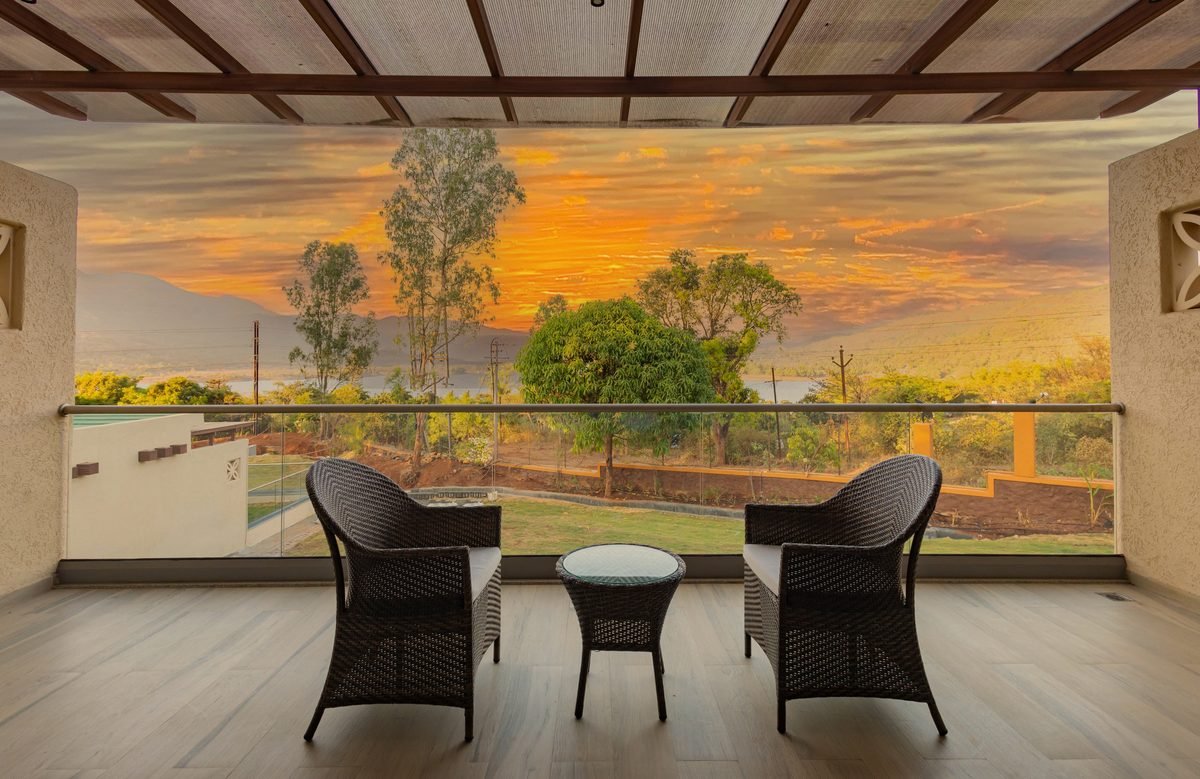 Balcony seating overlooking a sunset over the lake